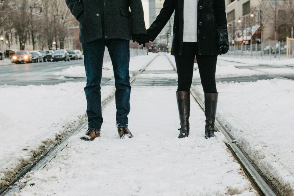 Holding hands on a snowy road