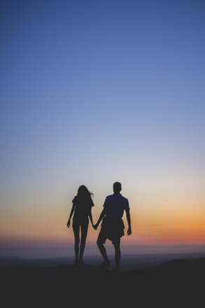 A couple's silhouettes at sunset